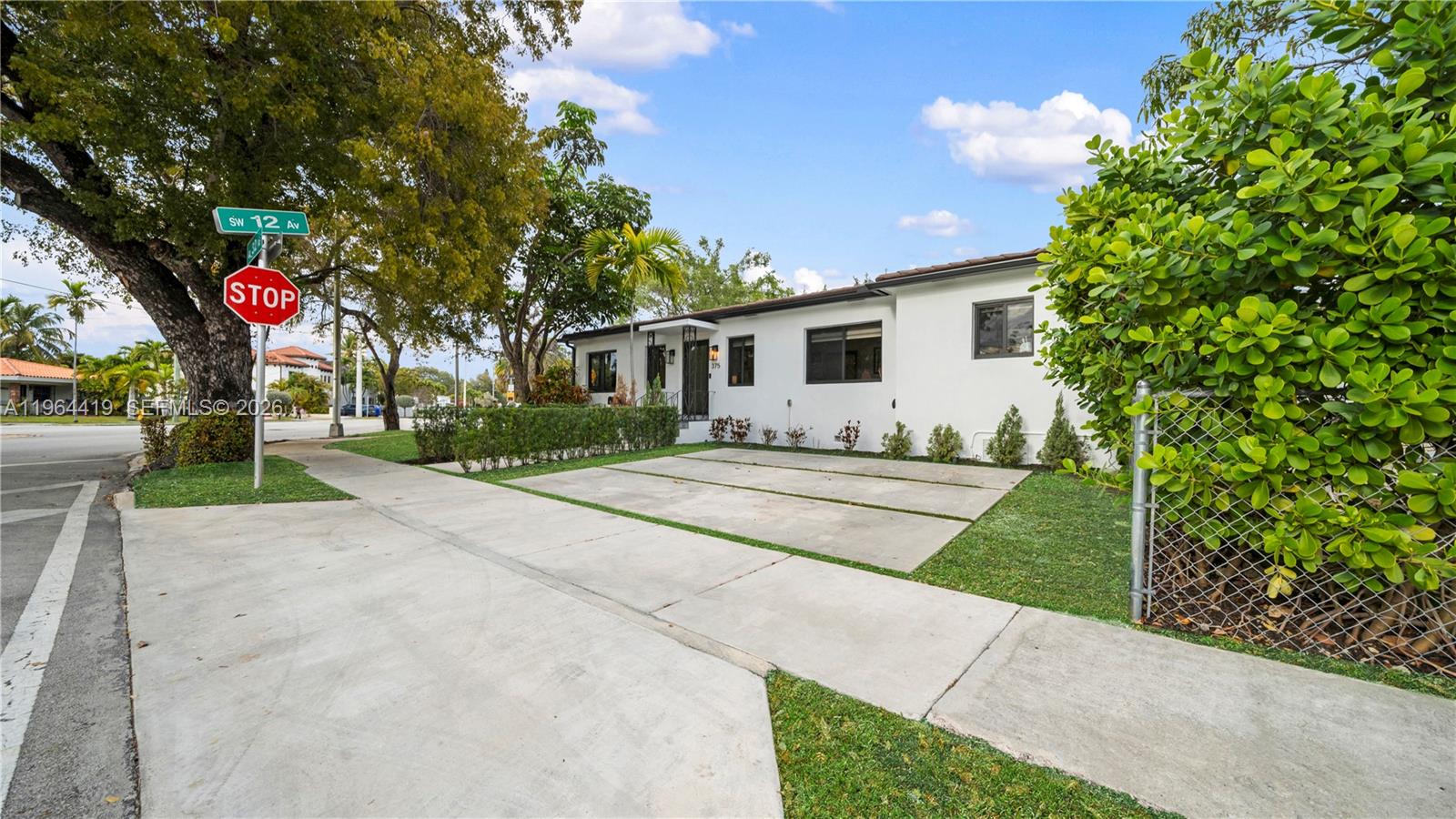 375 Southwest 32nd Road Miami, FL 33129 - Photo 3 of 39 a front view of a house with yard and trees