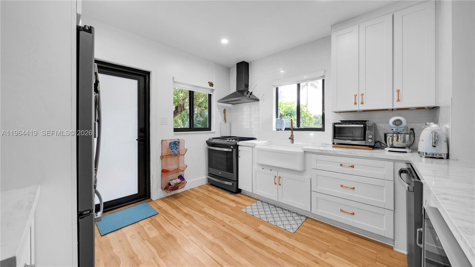 375 Southwest 32nd Road Miami, FL 33129 - Photo 10 of 39 a kitchen with white cabinets and appliances