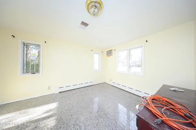 a view of a room with wooden floor and window