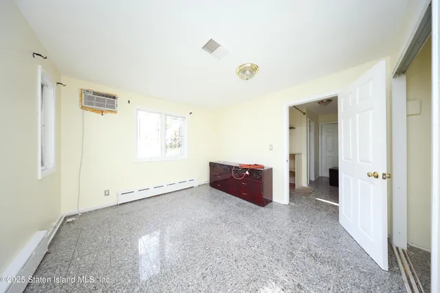 an empty room with windows and closet