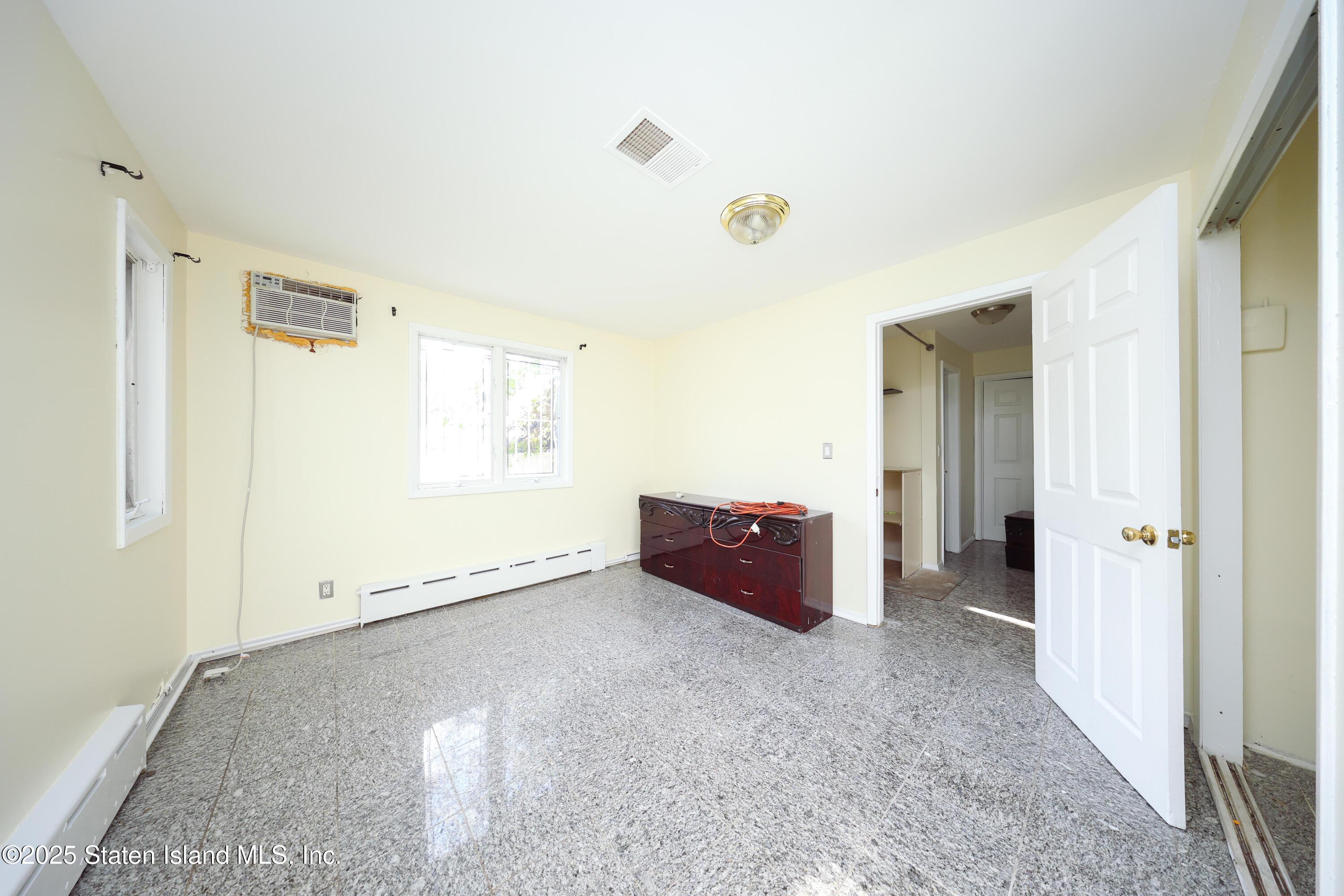 4664 Amboy Road Staten Island, NY 10312 - Photo 17 of 33 an empty room with windows and closet