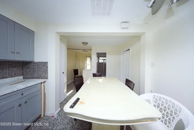 a en suite bathroom with a granite countertop sink and a mirror