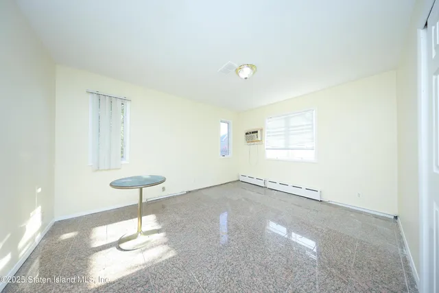 a view of an empty room and a window