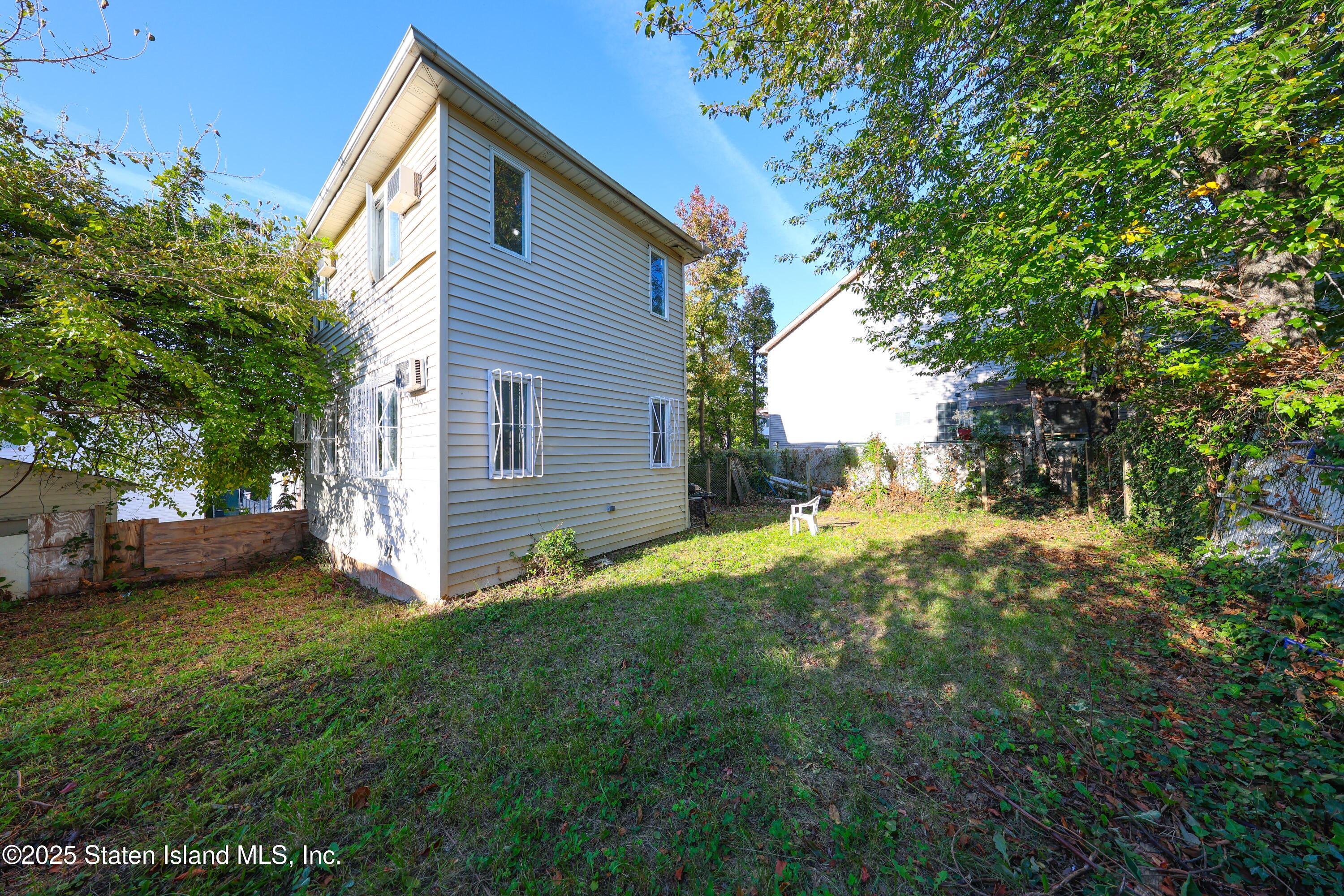 4664 Amboy Road Staten Island, NY 10312 - Photo 27 of 33 a view of backyard with a garden and trees