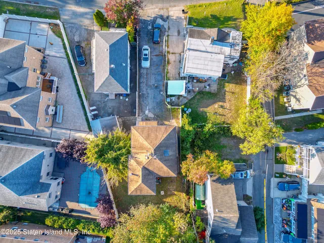 an aerial view of a houses with swimming pool