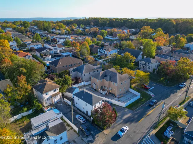 an aerial view of a houses with a swimming pool
