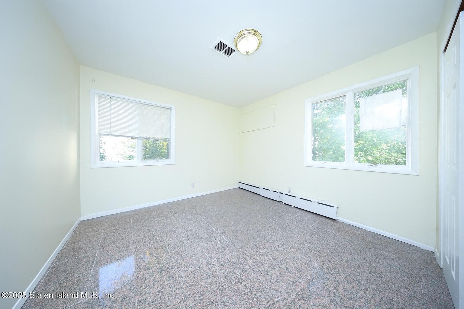 4664 Amboy Road Staten Island, NY 10312 - Photo 6 of 33 an empty room with a window