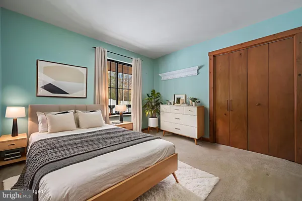 a view of a living room with kitchen area