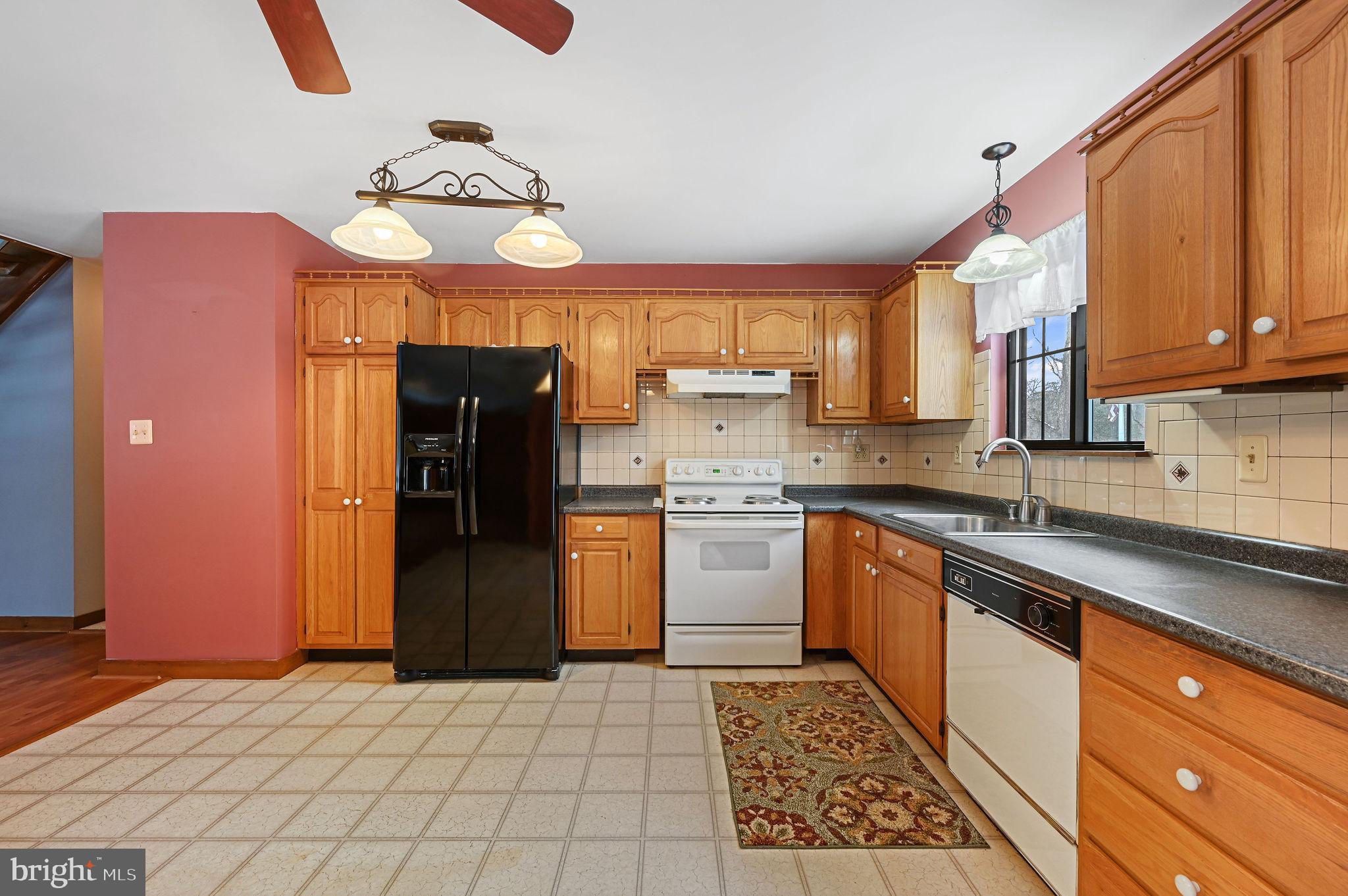 12820 Porters Landing Road Greensboro, MD 21639 - Photo 19 of 72 Warm country kitchen featuring rich wood cabinets