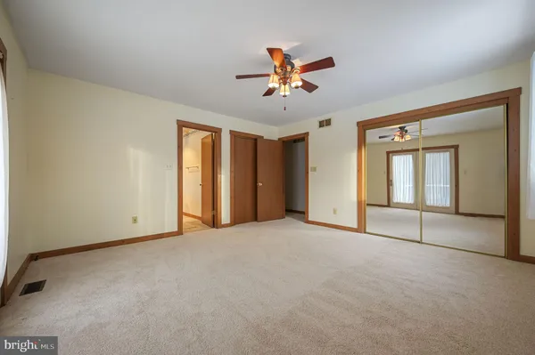a view of backyard with deck and outdoor seating