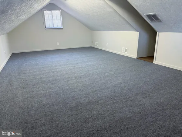 a view of a hall with wooden floor