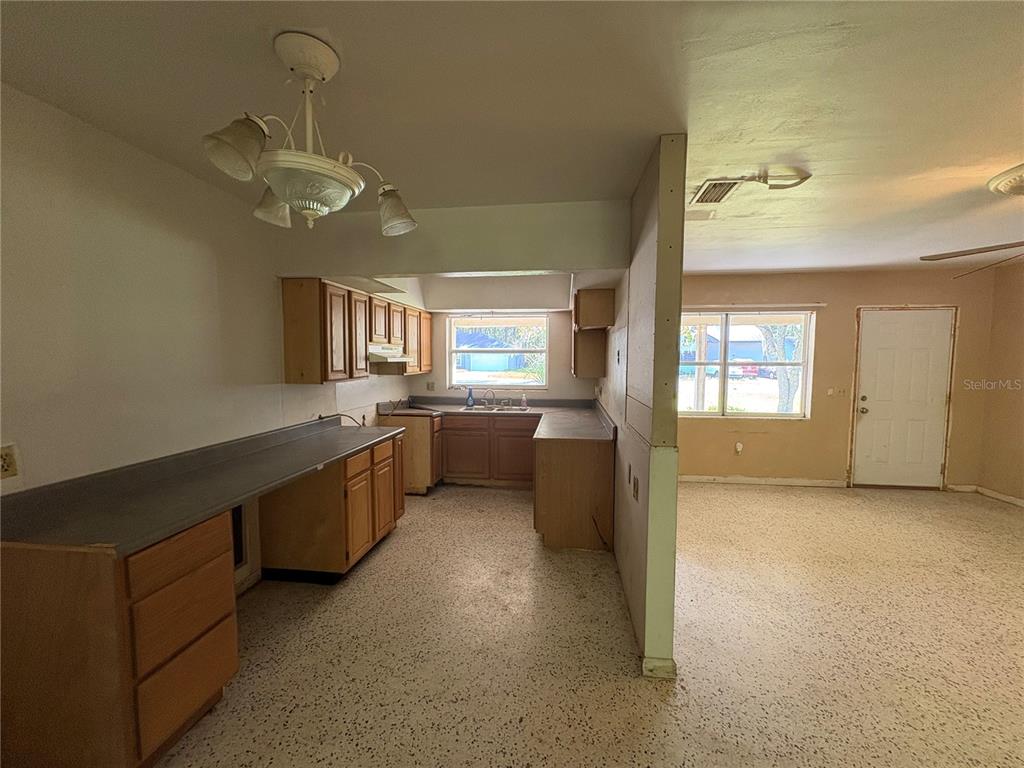 3922 South Apopka Avenue Inverness, FL 34452 - Photo 13 of 39 a large kitchen with a dishwasher a sink dishwasher a stove and a refrigerator with wooden floor