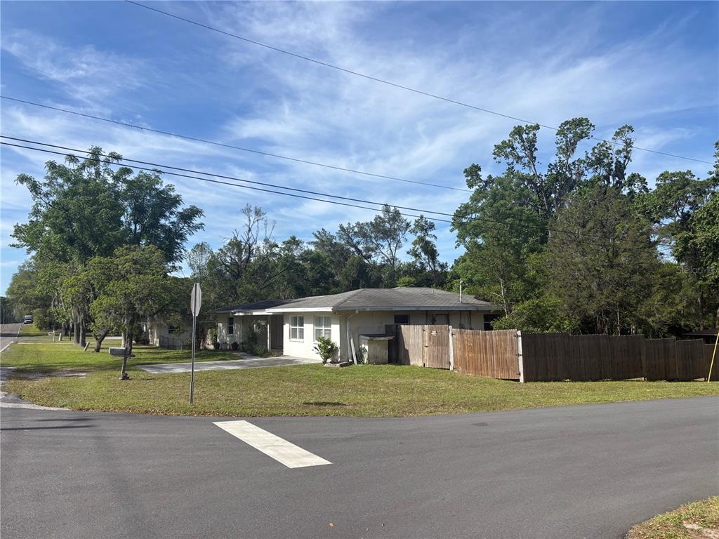 3922 South Apopka Avenue Inverness, FL 34452 - Photo 32 of 39 a front view of a house with a yard and a garage