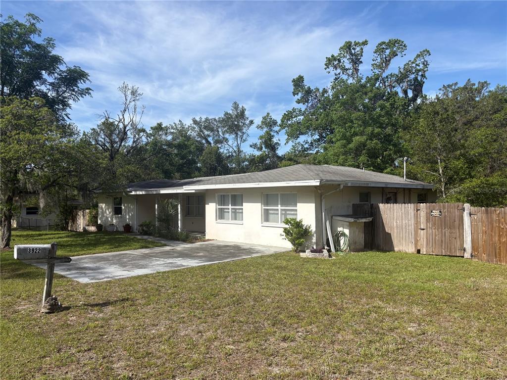 3922 South Apopka Avenue Inverness, FL 34452 - Photo 36 of 39 a front view of a house with a yard