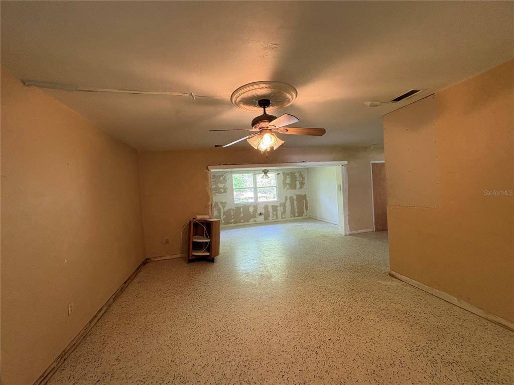 3922 South Apopka Avenue Inverness, FL 34452 - Photo 5 of 39 a view of a room with window and wooden floor