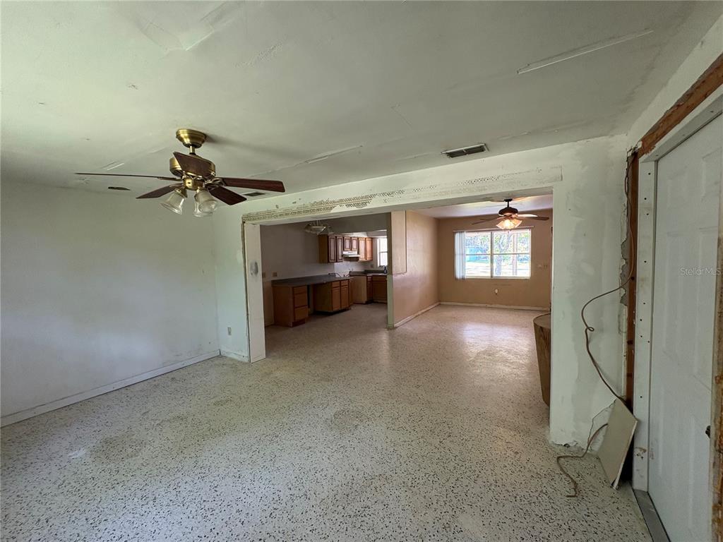 3922 South Apopka Avenue Inverness, FL 34452 - Photo 8 of 39 a view of empty room with fireplace and windows