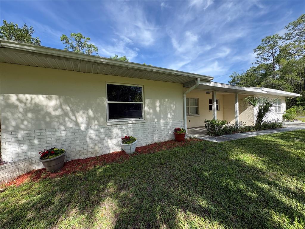 3922 South Apopka Avenue Inverness, FL 34452 - Photo 10 of 39 a front view of a house with garden