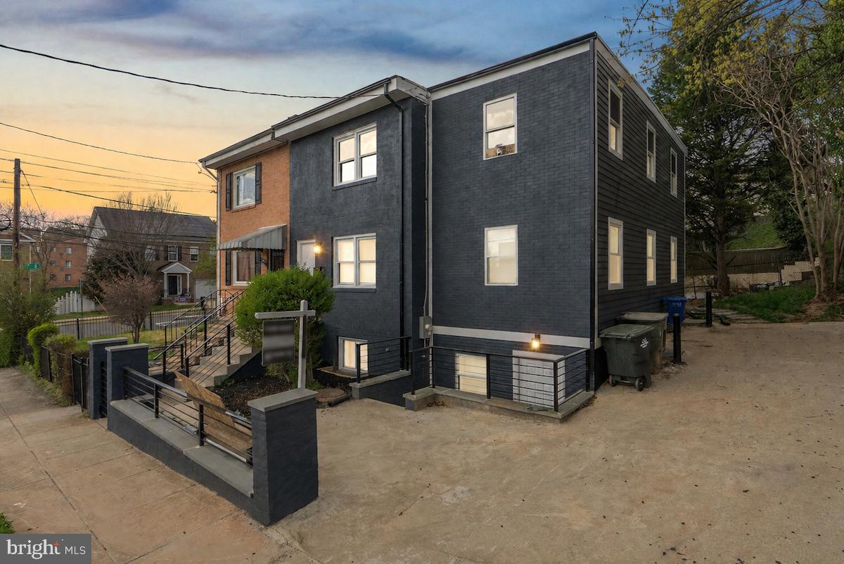 a view of a patio with couches and potted plants with sky view