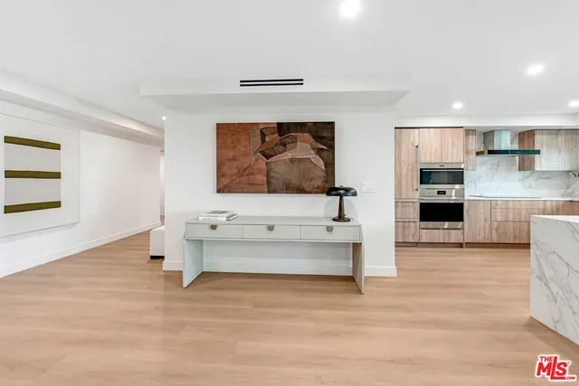 a bedroom with bed and a painting