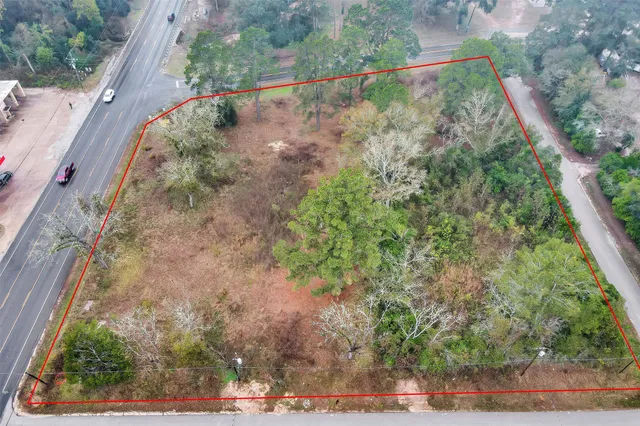 a view of a yard with wooden fence