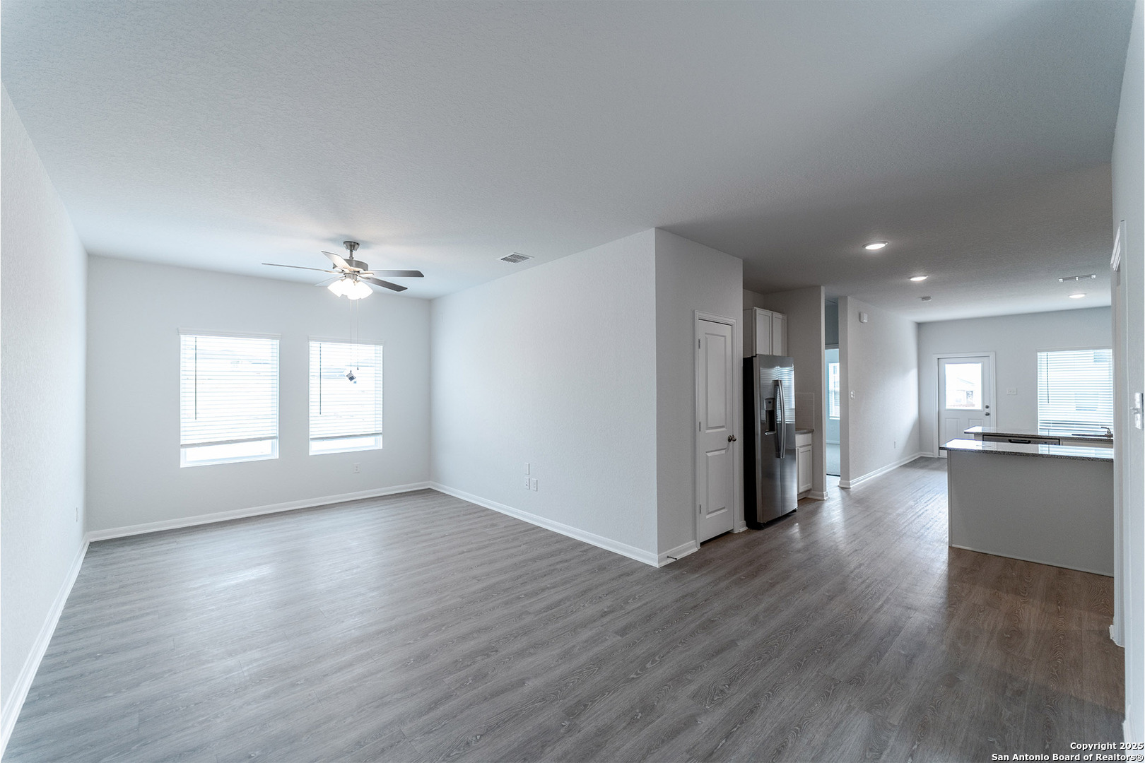 6632 Cibolo Springs Converse, TX 78109 - Photo 3 of 16 a view of an empty room with window and wooden floor
