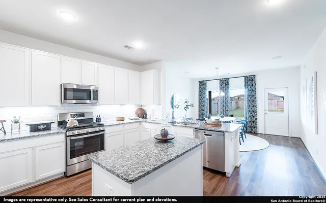 a kitchen with a sink a stove and cabinets