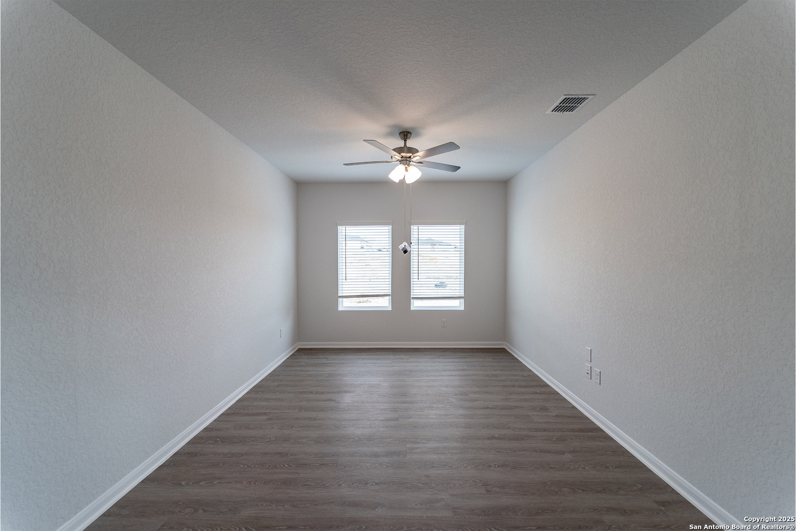 6632 Cibolo Springs Converse, TX 78109 - Photo 4 of 16 wooden floor in an empty room with a window