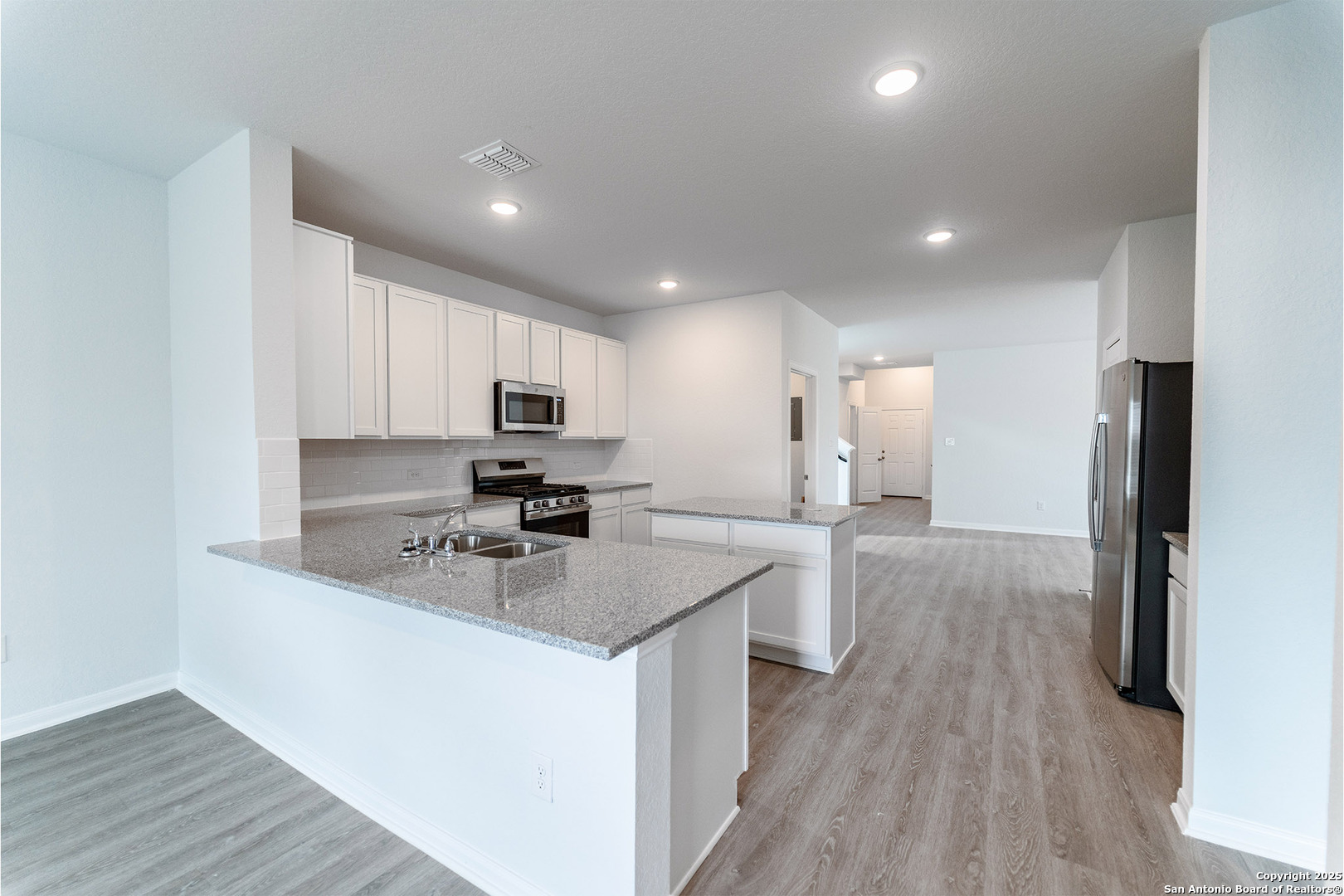 6632 Cibolo Springs Converse, TX 78109 - Photo 5 of 16 a kitchen with stainless steel appliances granite countertop a sink stove and refrigerator
