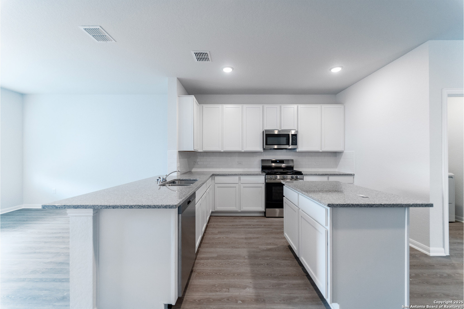 6632 Cibolo Springs Converse, TX 78109 - Photo 6 of 16 a kitchen with stainless steel appliances granite countertop a stove top oven a sink and dishwasher