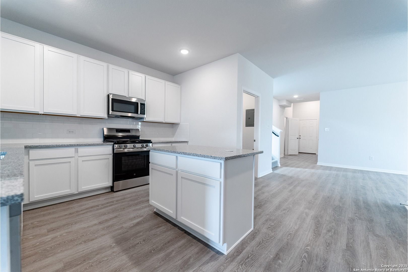 6632 Cibolo Springs Converse, TX 78109 - Photo 7 of 16 a kitchen with granite countertop white cabinets and stainless steel appliances