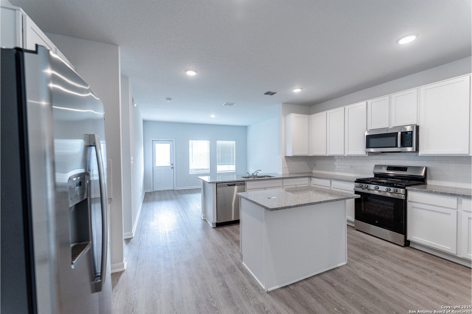 6632 Cibolo Springs Converse, TX 78109 - Photo 8 of 16 a kitchen with stainless steel appliances granite countertop a refrigerator a sink dishwasher a stove and white countertops with wooden floor