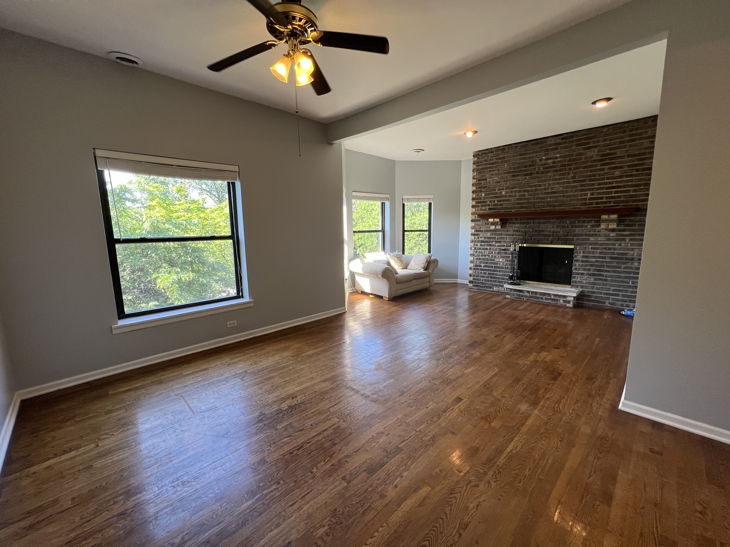 1024 West Byron Street, Unit 3W Chicago, IL 60613 - Photo 8 of 27 an empty room with windows fireplace and wooden floor