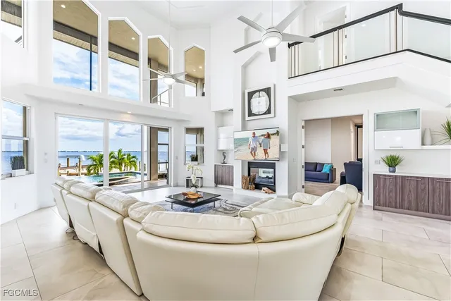 a living room with fireplace furniture and a chandelier