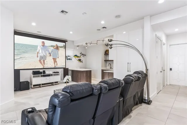 a living room with furniture a flat screen tv and a floor to ceiling window
