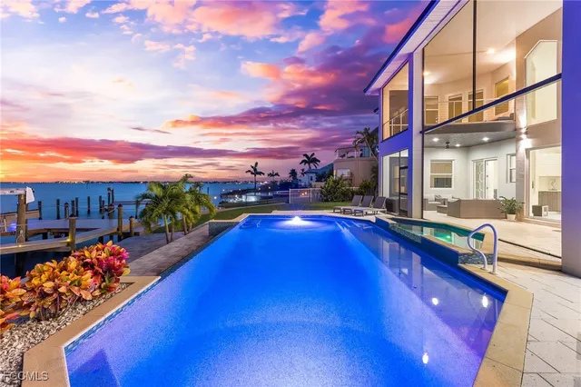 a view of a swimming pool with an outdoor seating