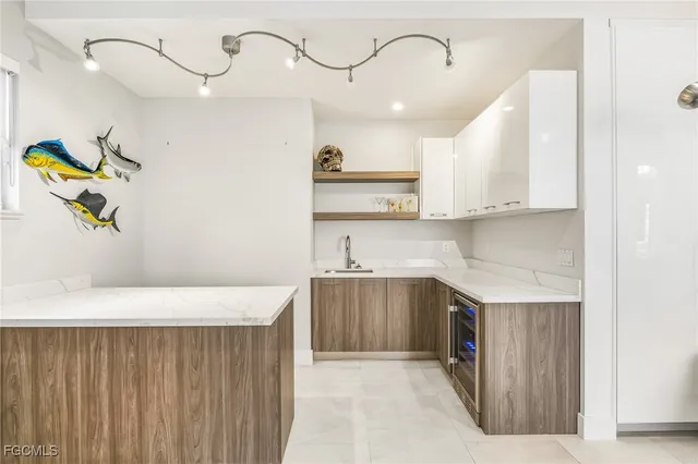 a kitchen with kitchen island a sink stainless steel appliances and cabinets