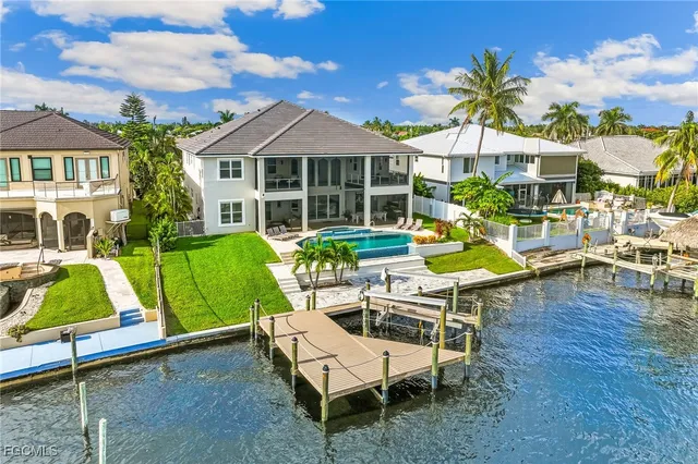 a view of a house with backyard porch and sitting area