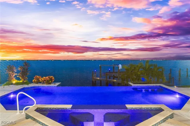 a view of a red building with swimming pool and sitting area