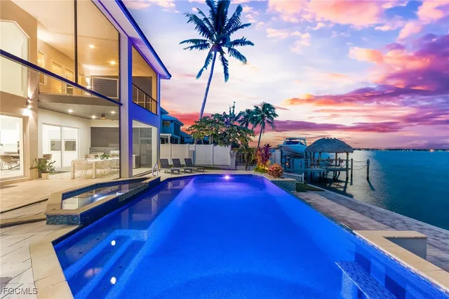 a swimming pool with outdoor seating and yard