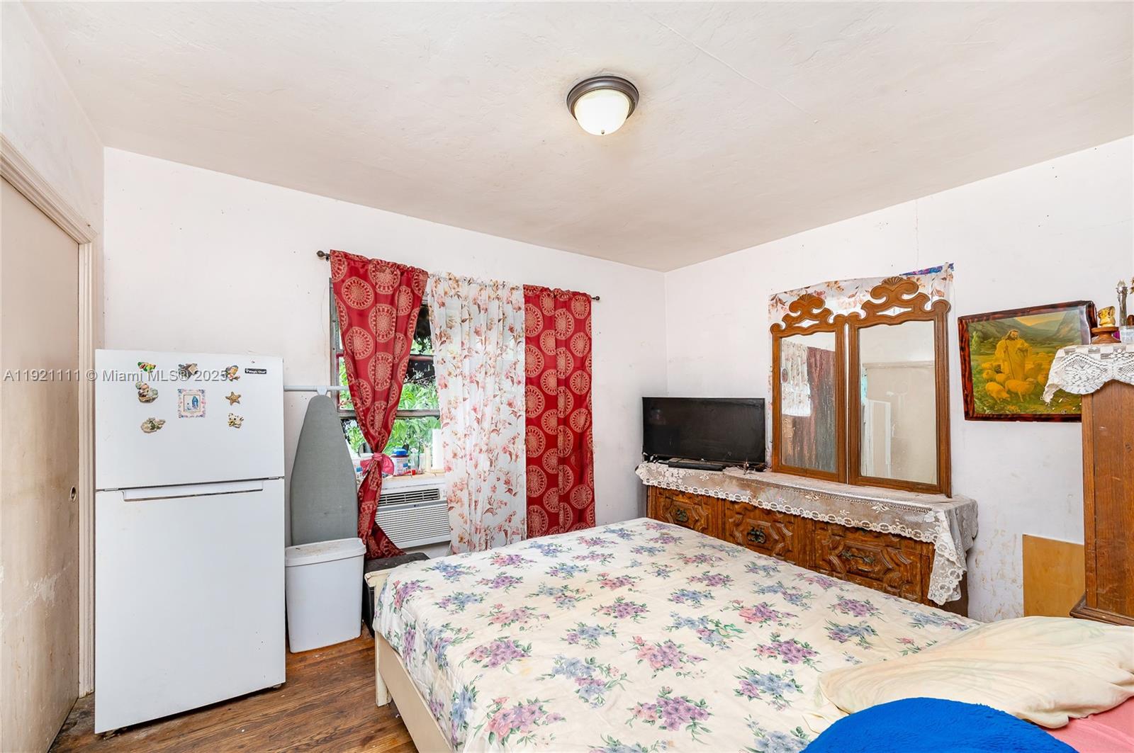 7712 Byron Avenue, Unit 4 Miami Beach, FL 33141 - Photo 11 of 12 a bedroom with a bed and a flat screen tv