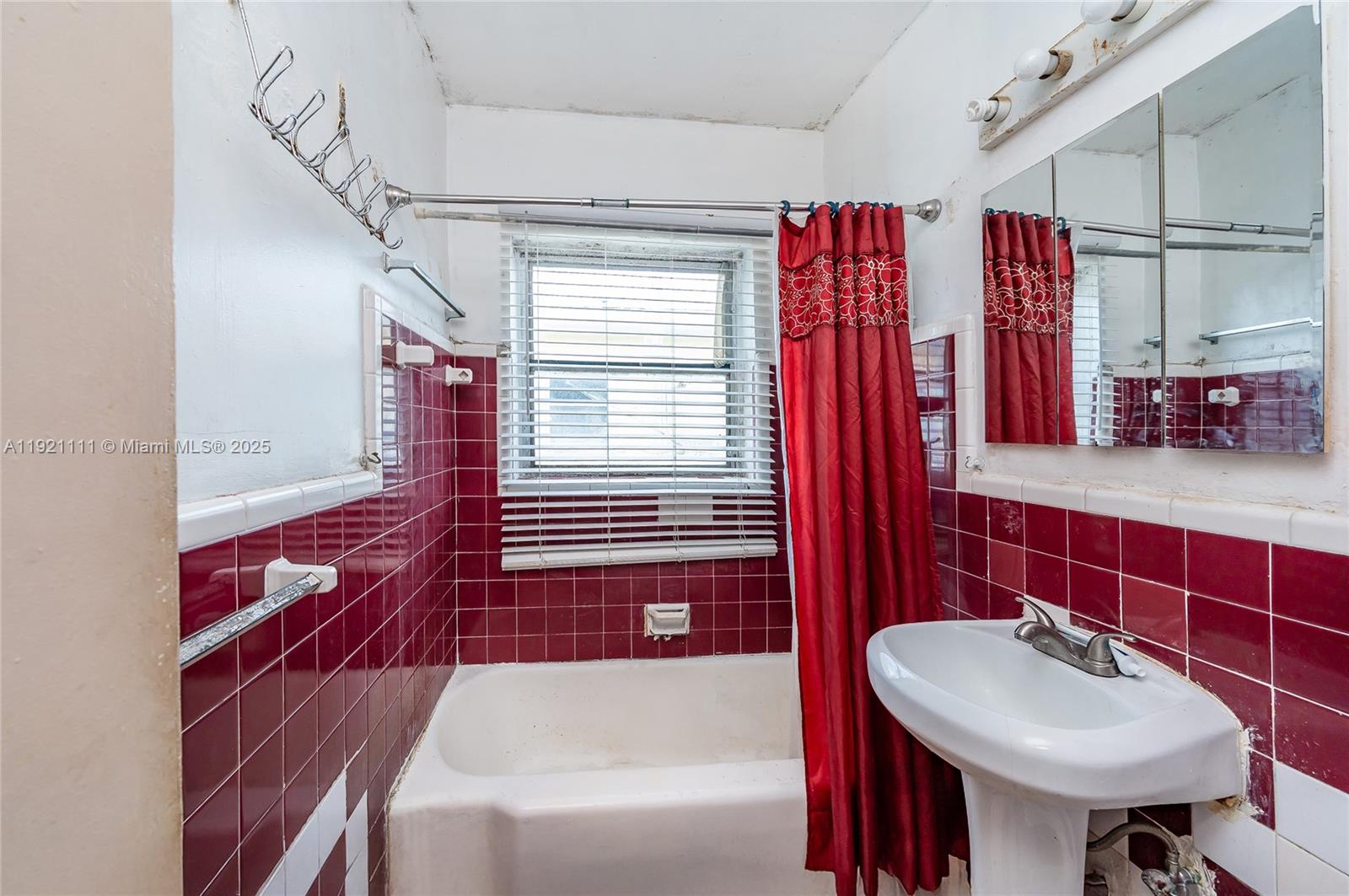 7712 Byron Avenue, Unit 4 Miami Beach, FL 33141 - Photo 12 of 12 a bathroom with a sink and a mirror