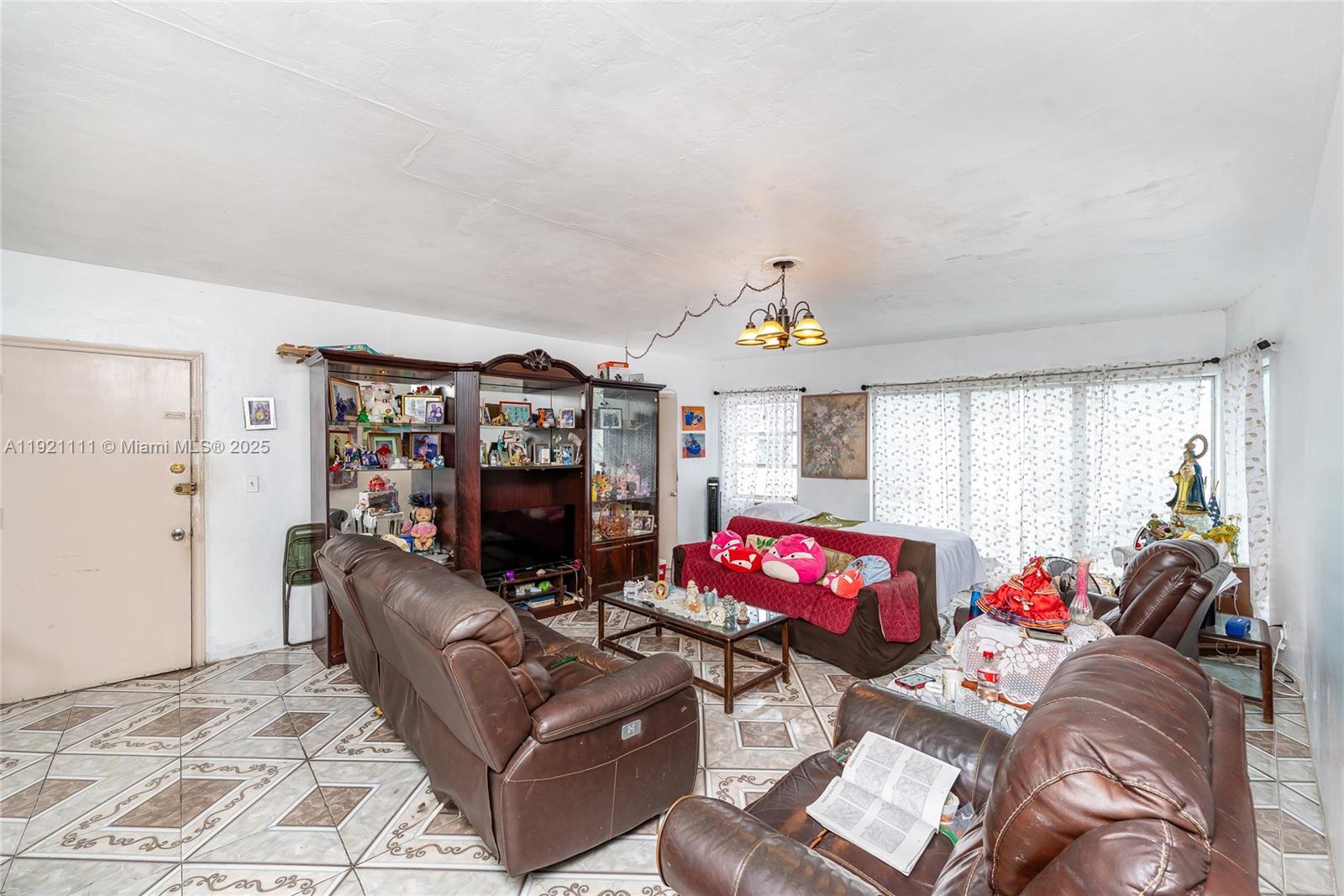 7712 Byron Avenue, Unit 4 Miami Beach, FL 33141 - Photo 3 of 12 a living room with furniture and a flat screen tv