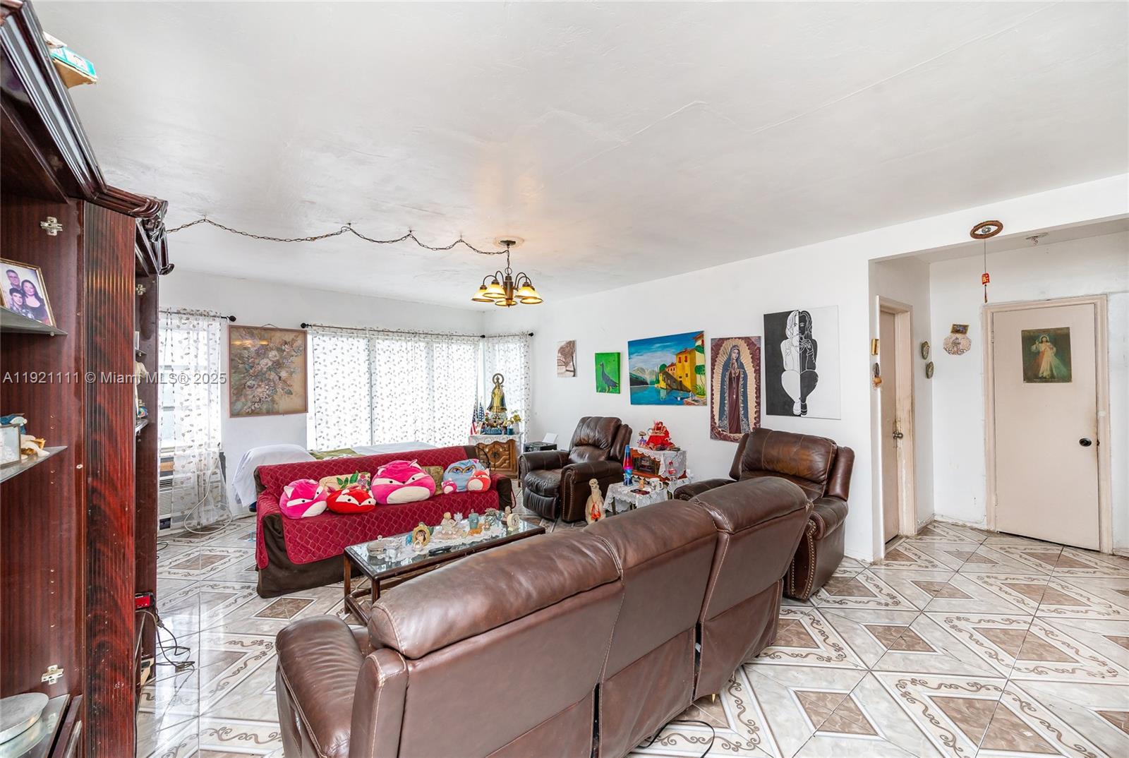 7712 Byron Avenue, Unit 4 Miami Beach, FL 33141 - Photo 4 of 12 a living room with furniture kitchen and a window
