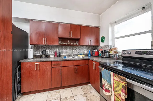 a kitchen with stainless steel appliances granite countertop a sink stove and microwave