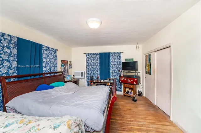 a bed room with a bed and a flat screen tv