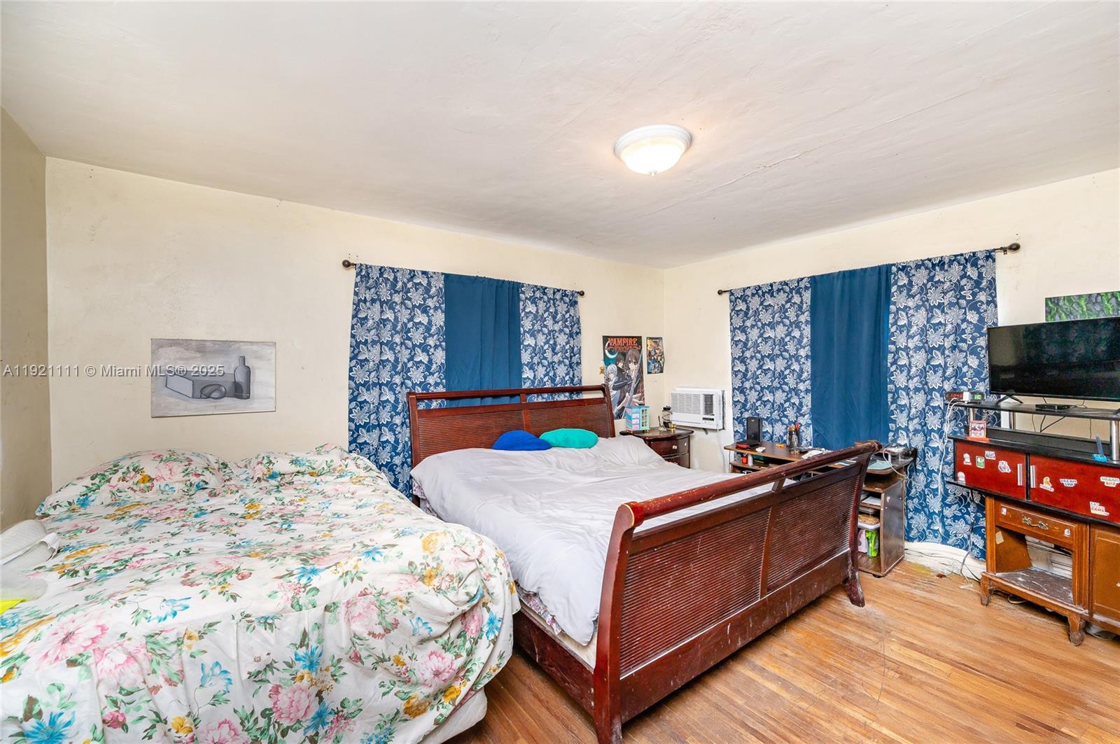 7712 Byron Avenue, Unit 4 Miami Beach, FL 33141 - Photo 10 of 12 a bedroom with a bed and a flat screen tv