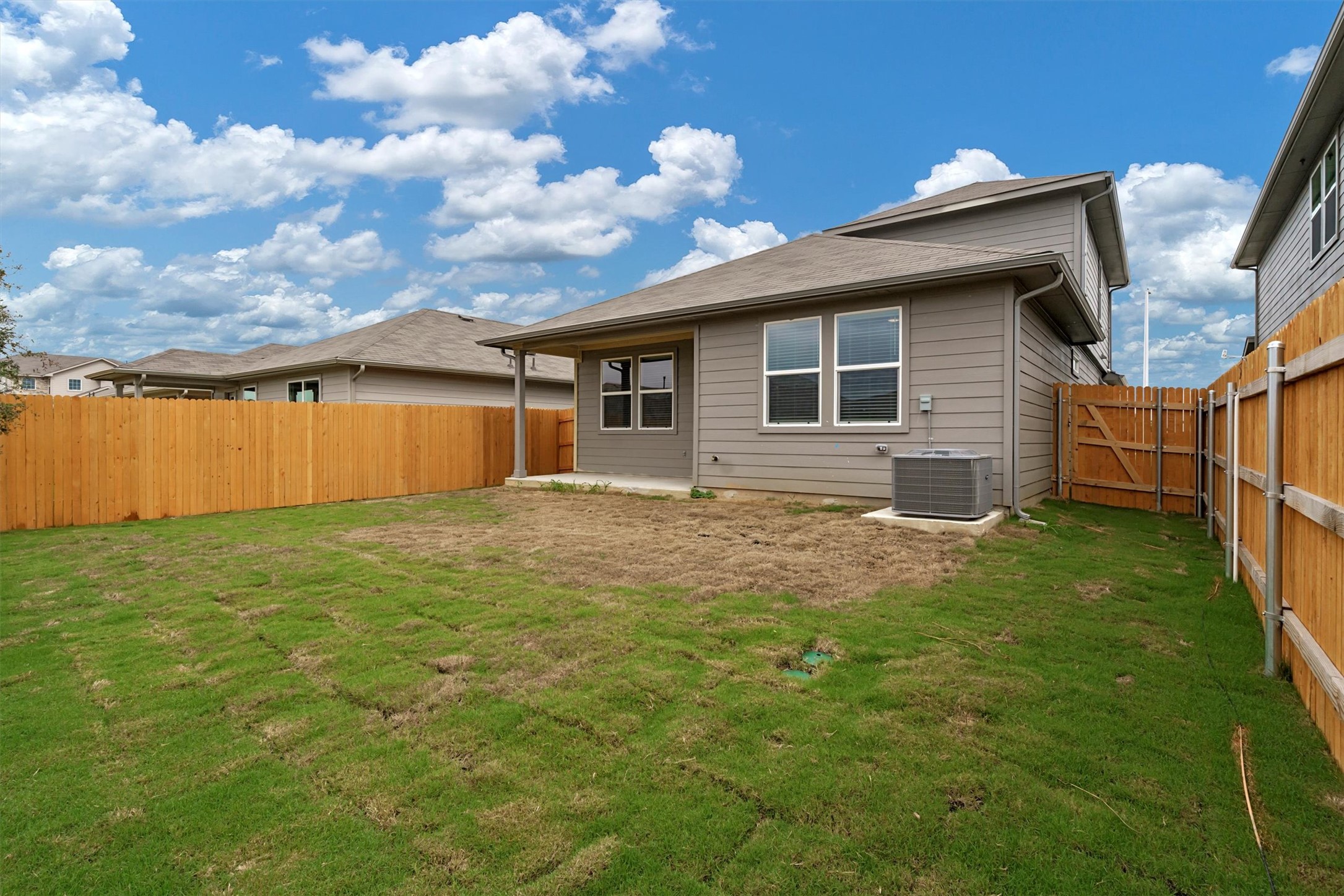 2909 Tweedy Trail Pflugerville, TX 78660 - Photo 26 of 27 A well-maintained wooden privacy fence encircles a spacious backyard with fresh sod.
