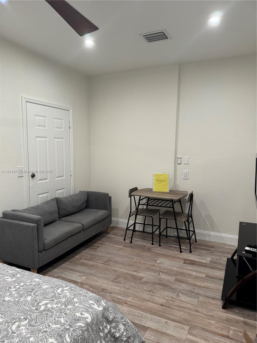 15603 Southwest 178th Street Miami, FL 33187 - Photo 1 of 11 a living room with furniture and a wooden floor