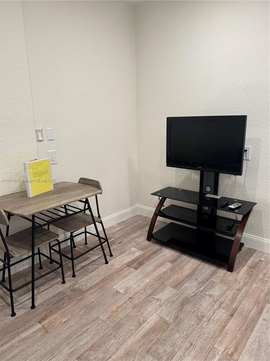 15603 Southwest 178th Street Miami, FL 33187 - Photo 2 of 11 a living room with furniture and a wooden floor