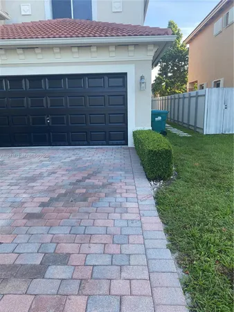 a view of a house with a backyard